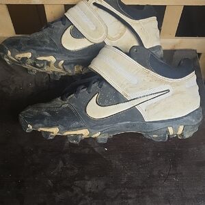 Nike Kids Black and Cream Sport Cleats.